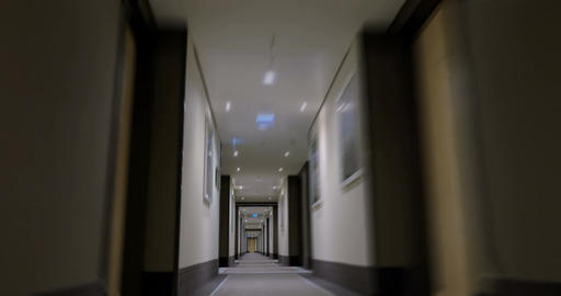 Timelapse of moving forward in empty light hotel corridor