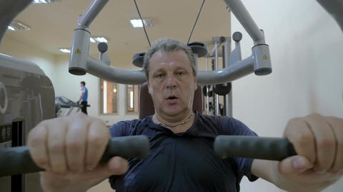 Sweaty man working out on exercise machine