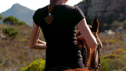 Pretty woman riding on a horse