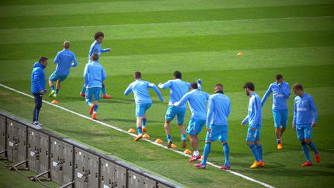 Football players doing dribbling exercise