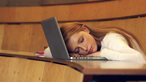 Student asleep sitting in class