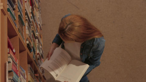 Student reading a book in the library