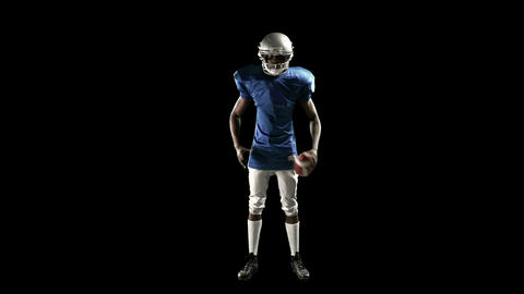 American football player holding ball