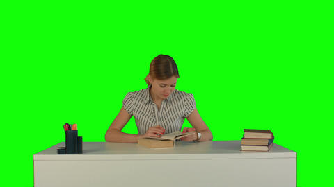 Beautiful female student read book on a Green Screen