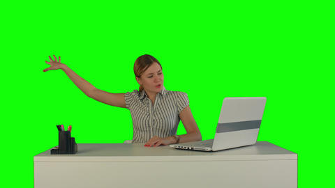 Woman is working on the laptop on a Green Screen