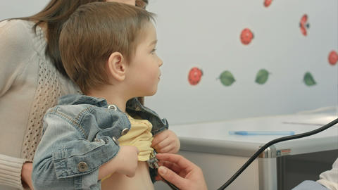 Hospital: Doctor Checks Heartbeat Of Young Boy