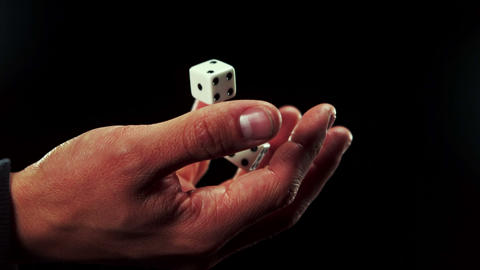 Hand catching a dice